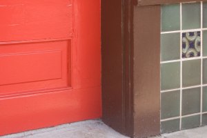 Close-up color & line shot of a door and post and the surrounding tiles
