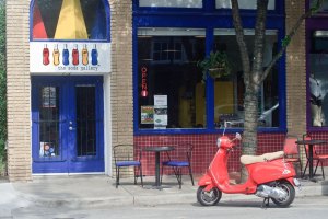 The Soda Gallery's blue, with red & yellow front door with red scooter out front